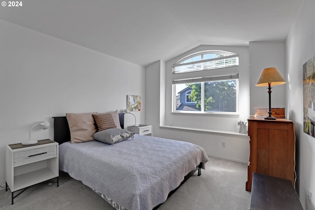 bedroom with carpet flooring and vaulted ceiling