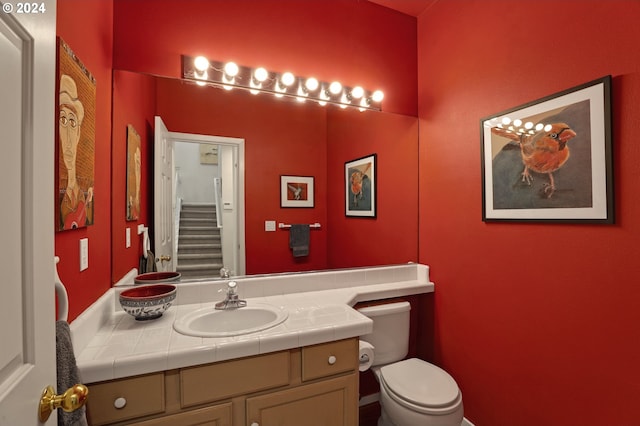 bathroom with toilet and vanity