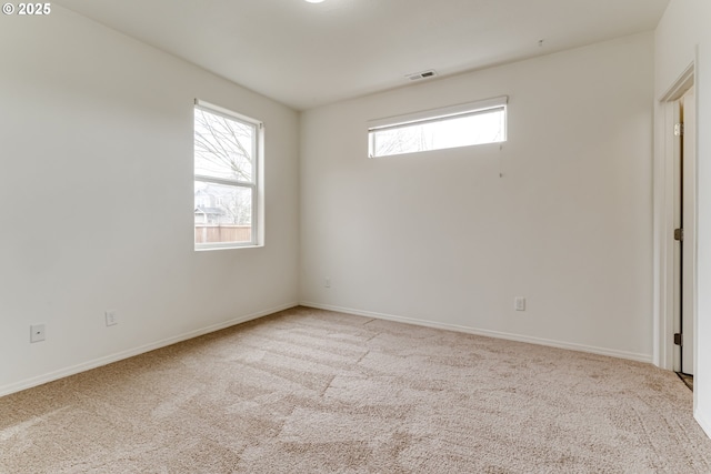 carpeted empty room featuring a healthy amount of sunlight