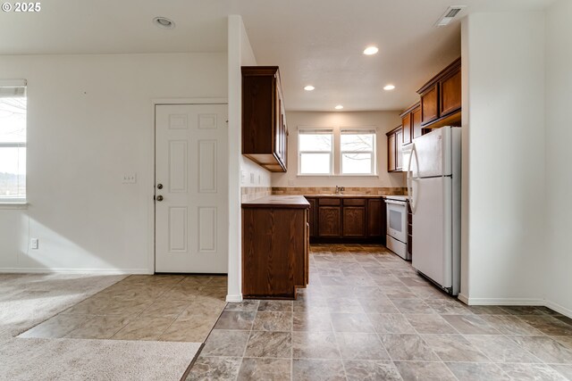 kitchen with decorative light fixtures and white refrigerator