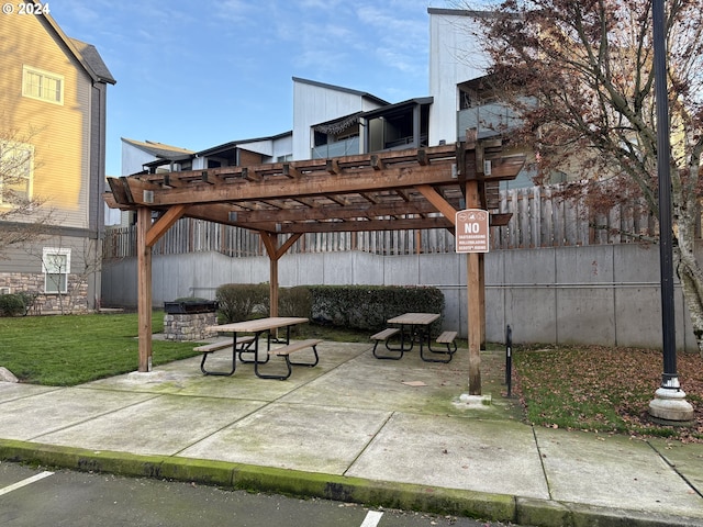 view of community featuring a pergola, a patio, and a yard