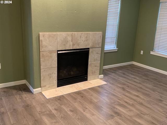 10733 NE Red Wing Way Unit 101, Hillsboro, OR 97006 - detailed view of wood finished floors, a fireplace, and baseboards