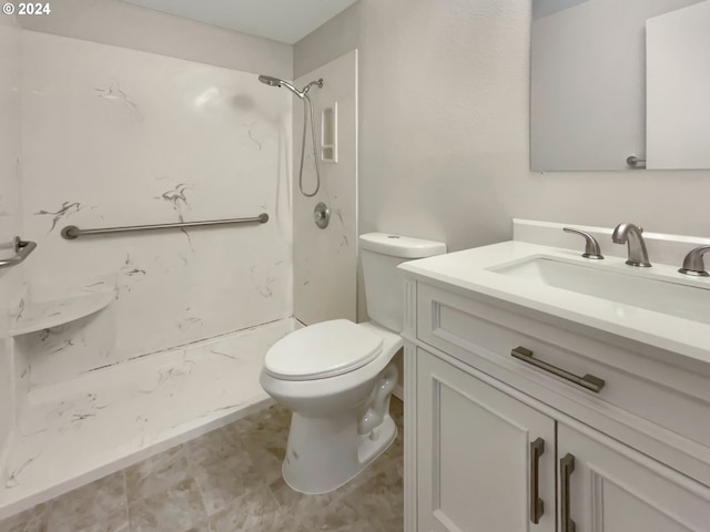 bathroom featuring a shower, vanity, and toilet