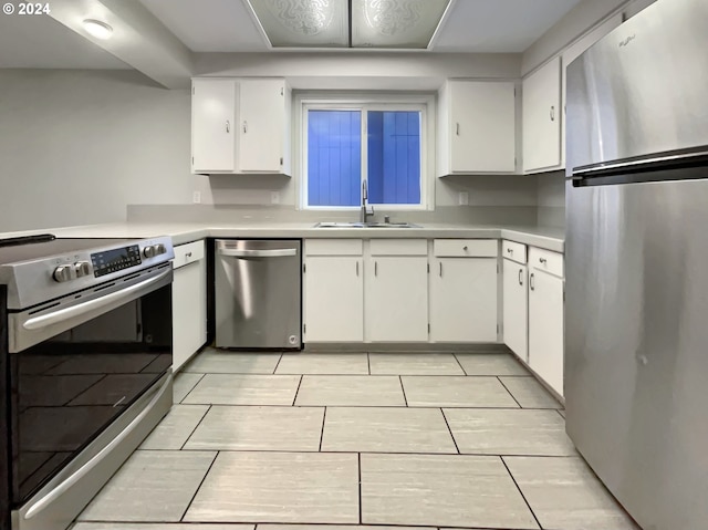 kitchen with sink, white cabinetry, and stainless steel appliances