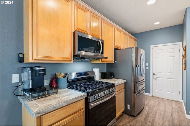 kitchen featuring light wood-type flooring and stainless steel appliances