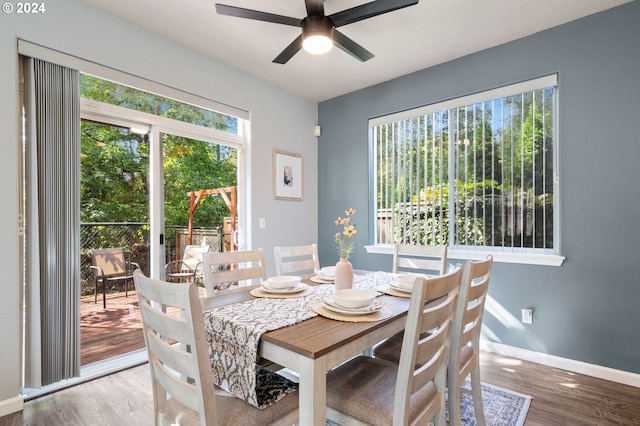 dining space featuring wood-type flooring and ceiling fan