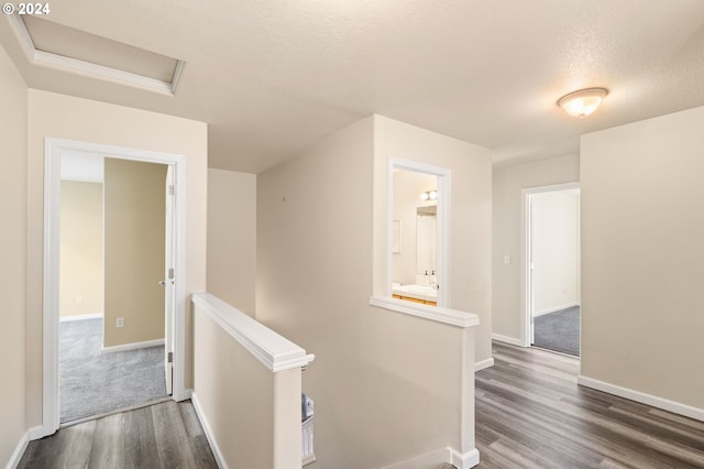 hall featuring dark hardwood / wood-style flooring and a textured ceiling