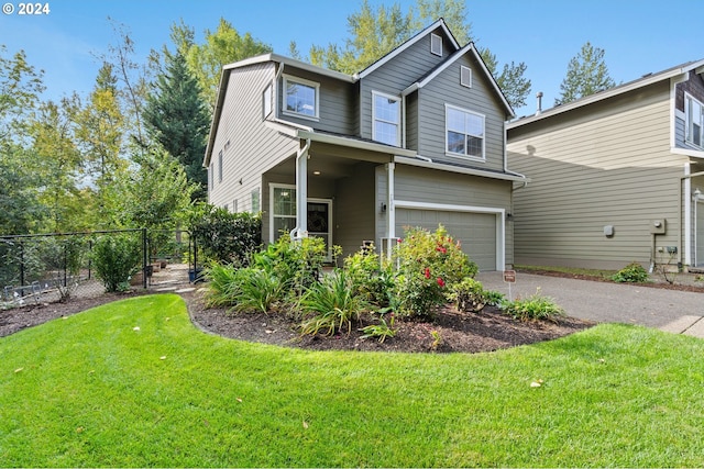 view of front of home with a front yard and a garage