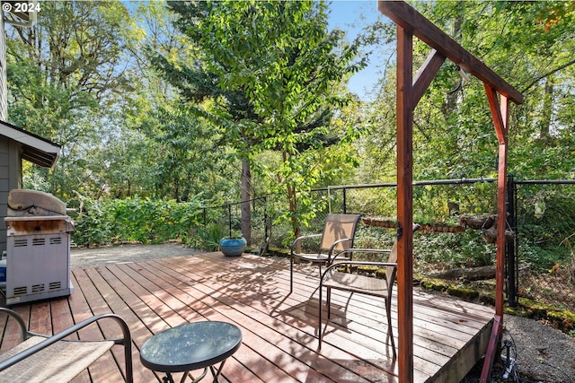 wooden deck featuring a grill