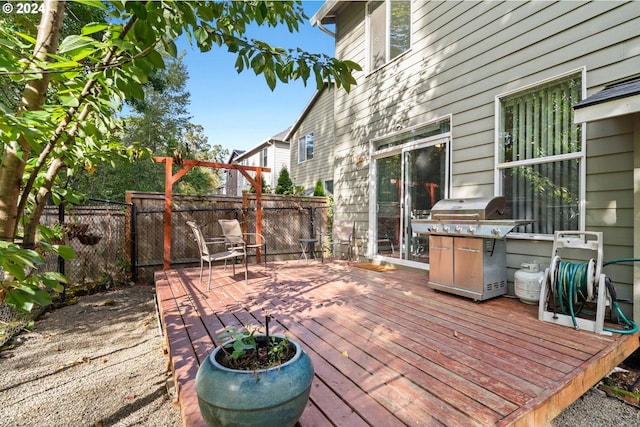 wooden terrace featuring area for grilling