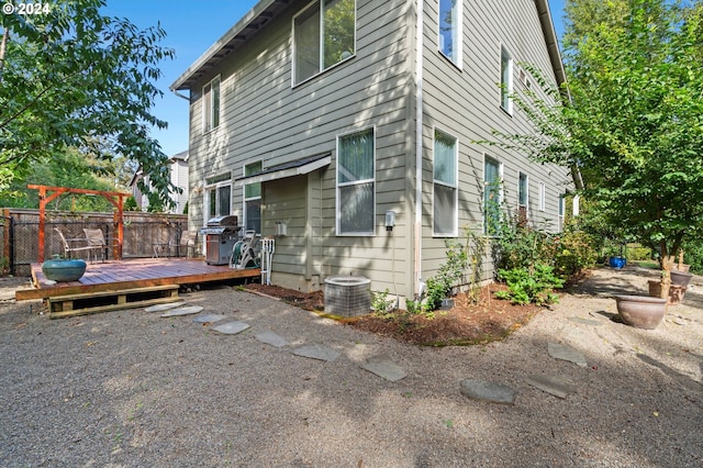 view of side of home featuring central air condition unit and a wooden deck