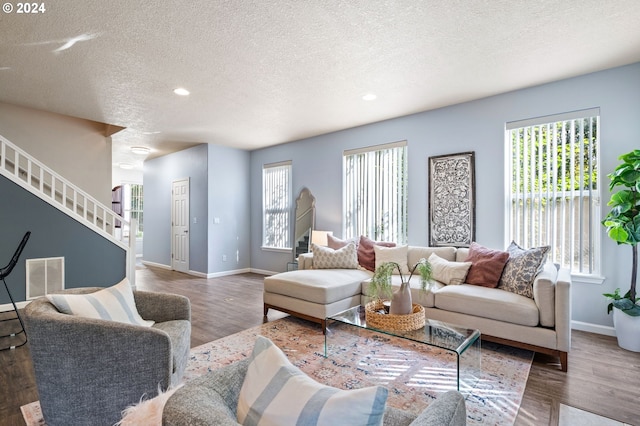 living room featuring dark hardwood / wood-style floors and a textured ceiling