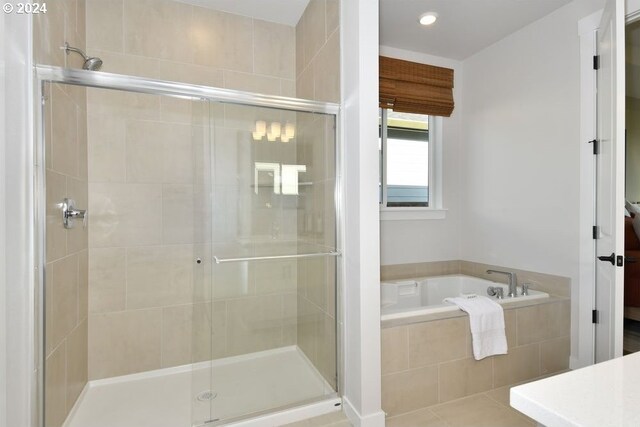 bathroom with tile patterned floors, vanity, and shower with separate bathtub