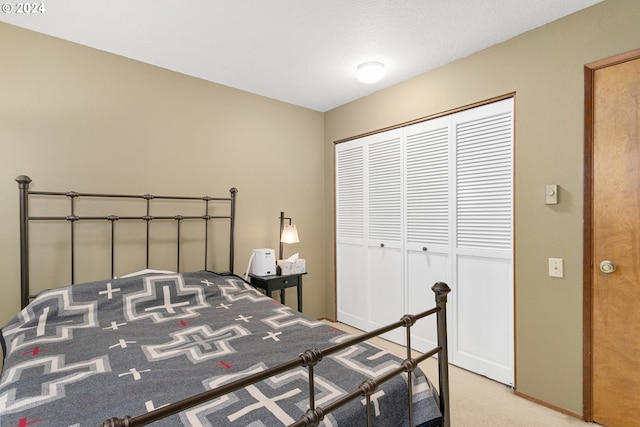 bedroom with carpet floors and a closet