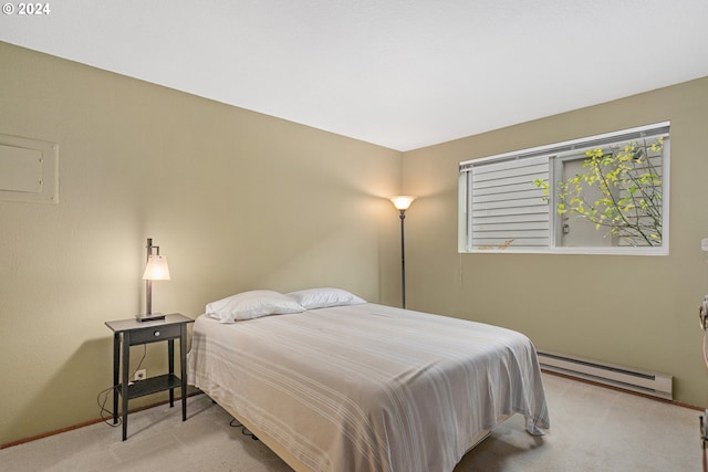 carpeted bedroom featuring a baseboard heating unit