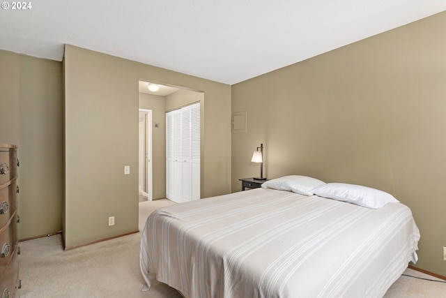 bedroom with light carpet and a closet