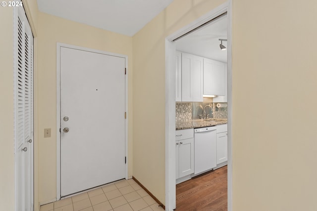 doorway featuring sink and light wood-type flooring