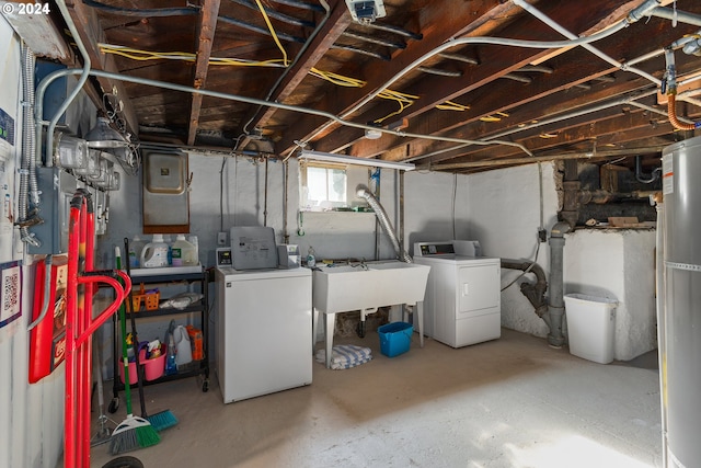 basement featuring water heater and separate washer and dryer