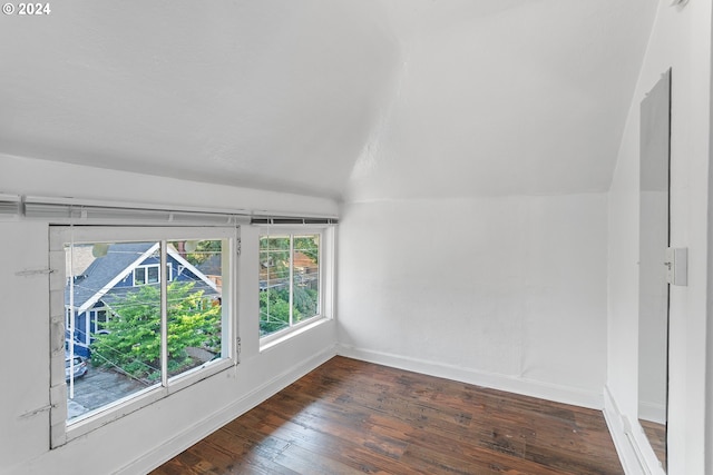 bonus room with lofted ceiling and dark hardwood / wood-style floors