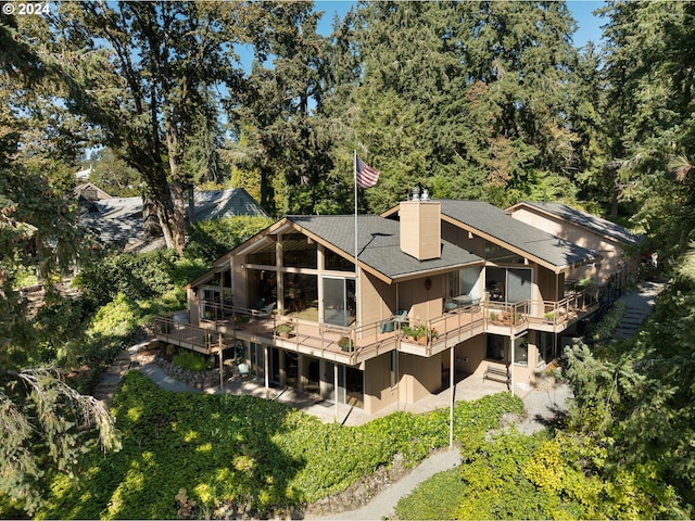 back of property featuring a patio area and a deck