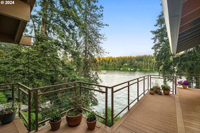 wooden terrace featuring a water view