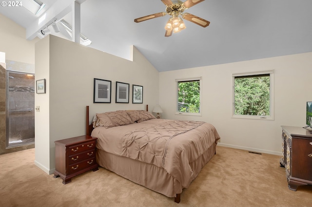 bedroom featuring a skylight, light colored carpet, high vaulted ceiling, and ceiling fan