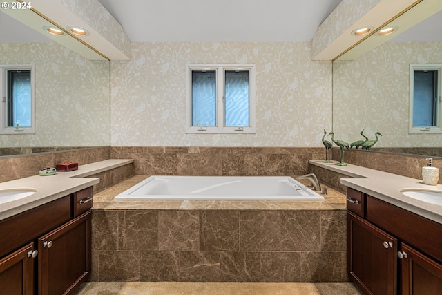 bathroom featuring vanity and tiled tub