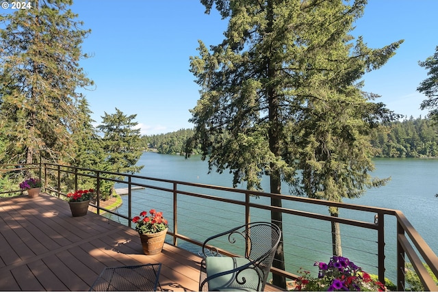 wooden terrace featuring a water view