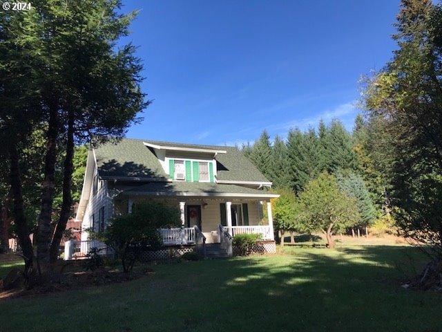 exterior space with covered porch and a lawn