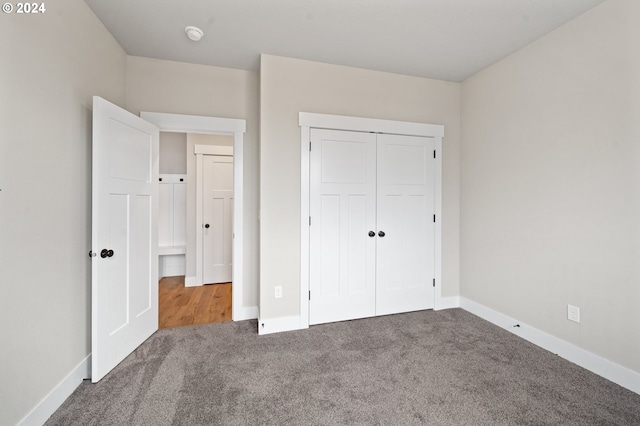 unfurnished bedroom featuring carpet floors and a closet