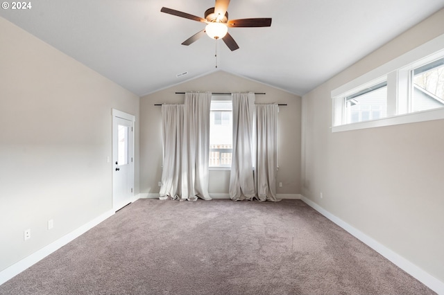 carpeted empty room featuring vaulted ceiling and ceiling fan