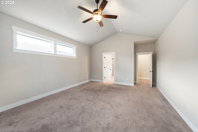 unfurnished bedroom with ceiling fan, light colored carpet, and vaulted ceiling