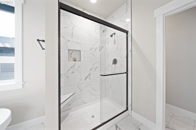 bathroom with a shower with shower door