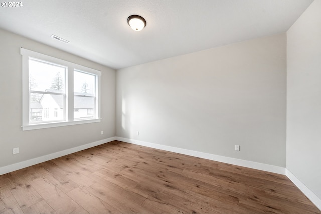 unfurnished room with wood-type flooring