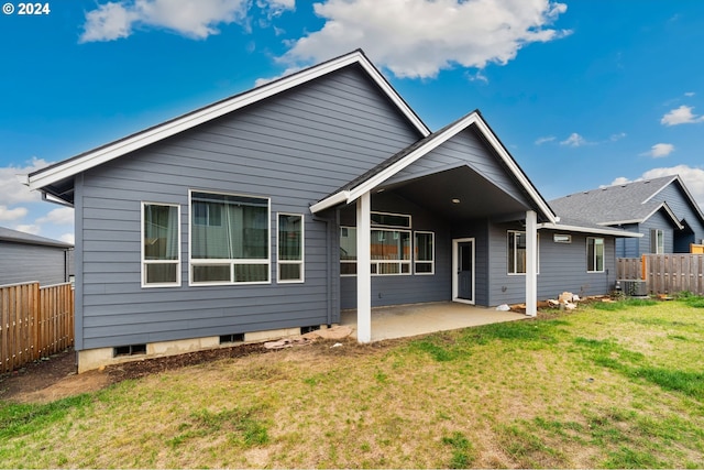 back of property with a patio, cooling unit, and a lawn