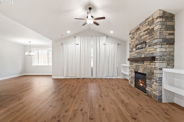 unfurnished living room featuring a fireplace, hardwood / wood-style floors, ceiling fan with notable chandelier, and lofted ceiling