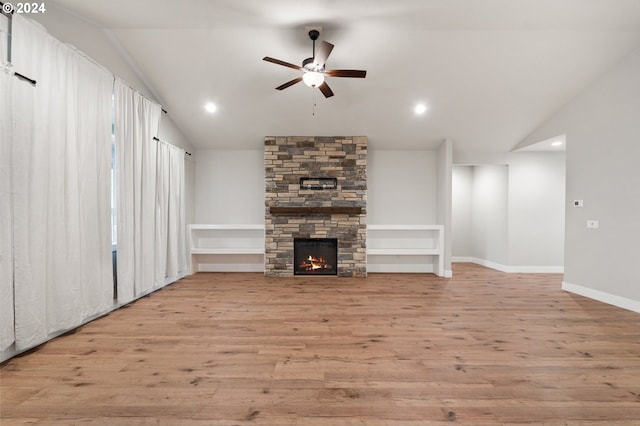 unfurnished living room with a fireplace, light hardwood / wood-style floors, and vaulted ceiling