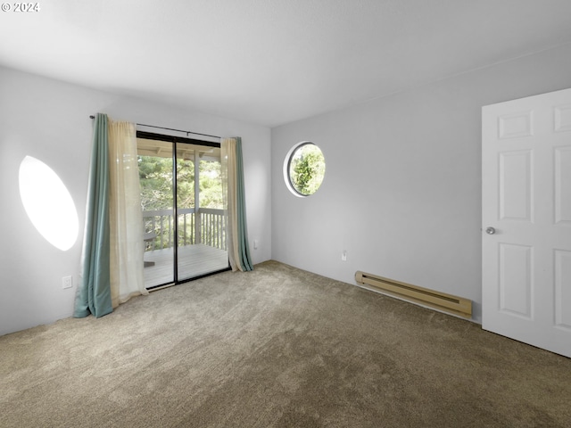 carpeted spare room featuring a baseboard radiator