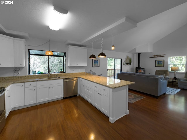 kitchen with kitchen peninsula, appliances with stainless steel finishes, dark hardwood / wood-style flooring, white cabinetry, and lofted ceiling