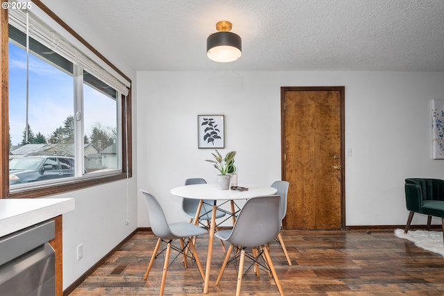 dining room with a textured ceiling, dark wood-type flooring, and baseboards