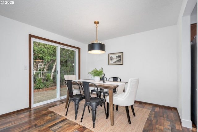 dining room with baseboards and dark wood-style flooring