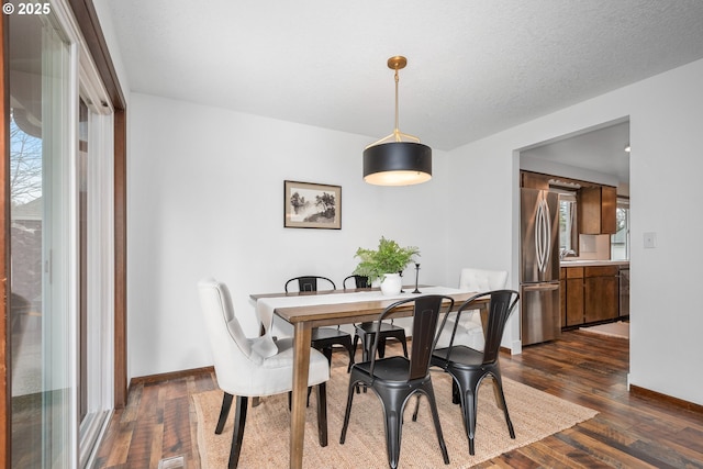 dining area with plenty of natural light, baseboards, and dark wood-style flooring