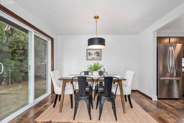 dining area featuring baseboards and dark wood-style flooring