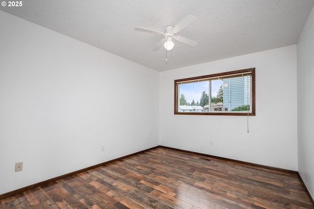 unfurnished room with visible vents, baseboards, a textured ceiling, a ceiling fan, and dark wood-style flooring