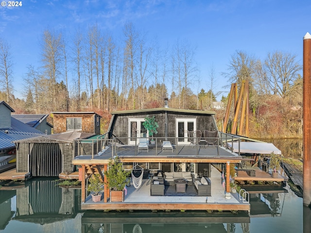 back of house with outdoor lounge area, french doors, and a deck