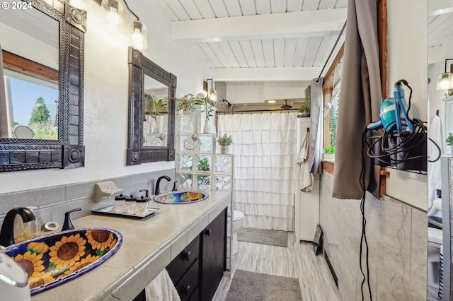 bathroom featuring vanity, wooden ceiling, beamed ceiling, hardwood / wood-style floors, and toilet