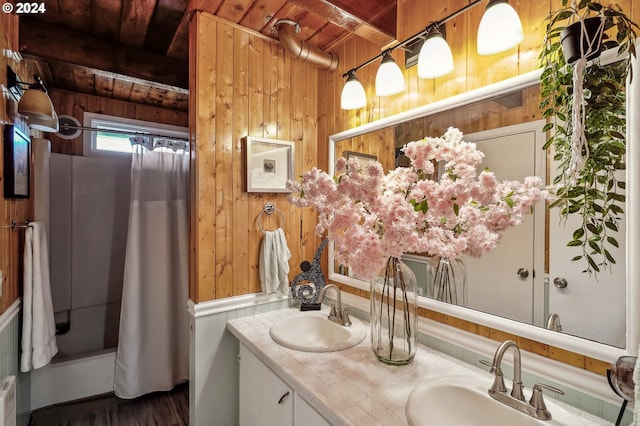 bathroom with beam ceiling, vanity, wooden ceiling, and wood walls