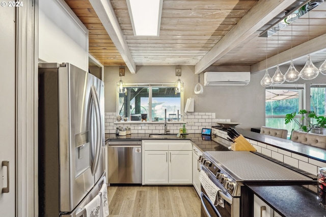 kitchen with stainless steel appliances, beamed ceiling, a wall unit AC, white cabinets, and wood ceiling