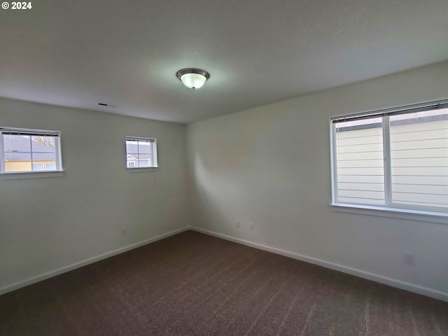 empty room with dark carpet