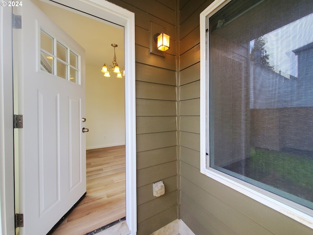 exterior space featuring a notable chandelier and wood-type flooring